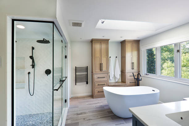 bathroom remodelling A contemporary modern bathroom design. featuring a freestanding bathtub and a glass shower stall